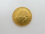 a gold coin with a picture of a man on it