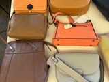 a lot of purses that are on a table