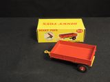 an image of a red toy truck with a box on a black surface