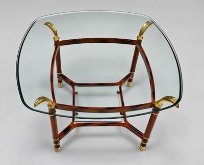 a glass and brass coffee table with a glass top