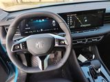 the interior of a car with a steering wheel and dashboard controls