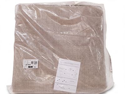 a blanket wrapped in a plastic bag on a white surface