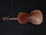 an old violin on a black background with a string