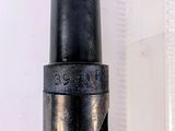 a close up of a black pipe on a white surface