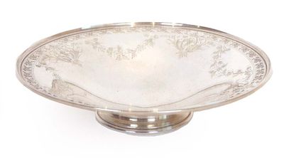 a silver plate on a stand on a white background