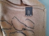 a label on the back of a jacket with a picture of a dog on it
