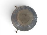 a metal plate with a metal handle on a white surface
