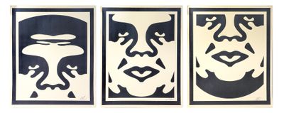 three black and white paintings of faces on a white wall