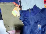 a pile of clothes and a bag on a table