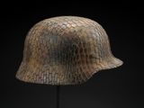 an image of a helmet on a stand against a black background