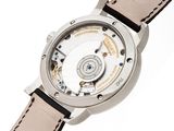 a close up of a watch on a white surface