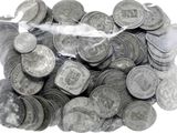 a bag full of silver coins on a white surface
