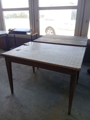 two tables that are sitting in front of a window