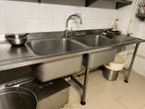 a kitchen with a sink and a pot on the counter