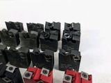 a lot of red and black electrical switches on a white surface