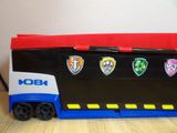 a toy truck that has a bunch of stickers on the side of it