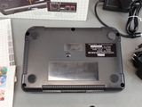 a laptop that is sitting on a table with other electronics