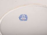 a white plate with a blue flower design on it