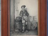 an old picture of a young boy standing in front of a barrel