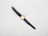 a gold watch with a black band and a white face