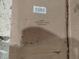 a cardboard box sitting on top of a concrete floor