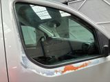 a white truck with rust on the side of it ' s windows