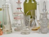 many different types of glass vases and glasses on the table