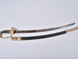 two swords with gold and black handles on a white surface