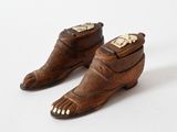 pair of brown leather shoes with gold toe decorations on them