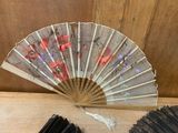 a fan that is sitting on a table next to a bunch of sticks