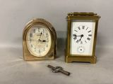 two clocks sitting next to each other on a table