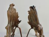two pieces of wood that have been carved into the shape of birds