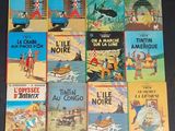 many children ' s books are lined up on a black surface