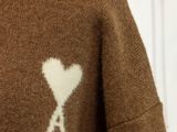a brown sweater with a white heart on it