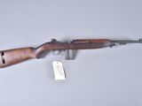 the rifle is laying on the table with a tag on it
