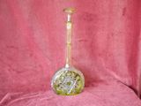 a glass vase that is sitting on a pink cloth