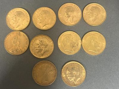 six different types of gold coins on a gray surface