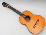 a close up of an acoustic guitar on a white surface