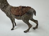 a small statue of a deer with a long horn