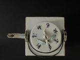 a white clock with a bird on it on a black background