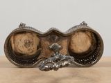 a silver plate with a pair of glasses on top of it