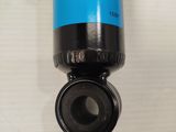 a close up of a blue and black water filter on a white surface