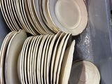 a lot of plates that are stacked in a box