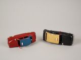 two toy cars sitting next to each other on a white surface