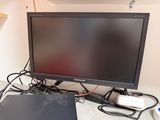 a computer monitor sitting on top of a desk next to a laptop