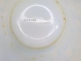 a close up of a white bowl with a brown spot on it