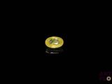 a close up of a yellow sapphire on a black surface