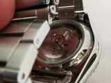 a person that is holding a watch in their hand