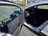 a car that has its door open on the side of the road