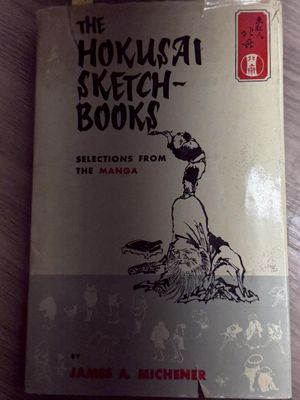 an old book sitting on top of a table next to a wooden table